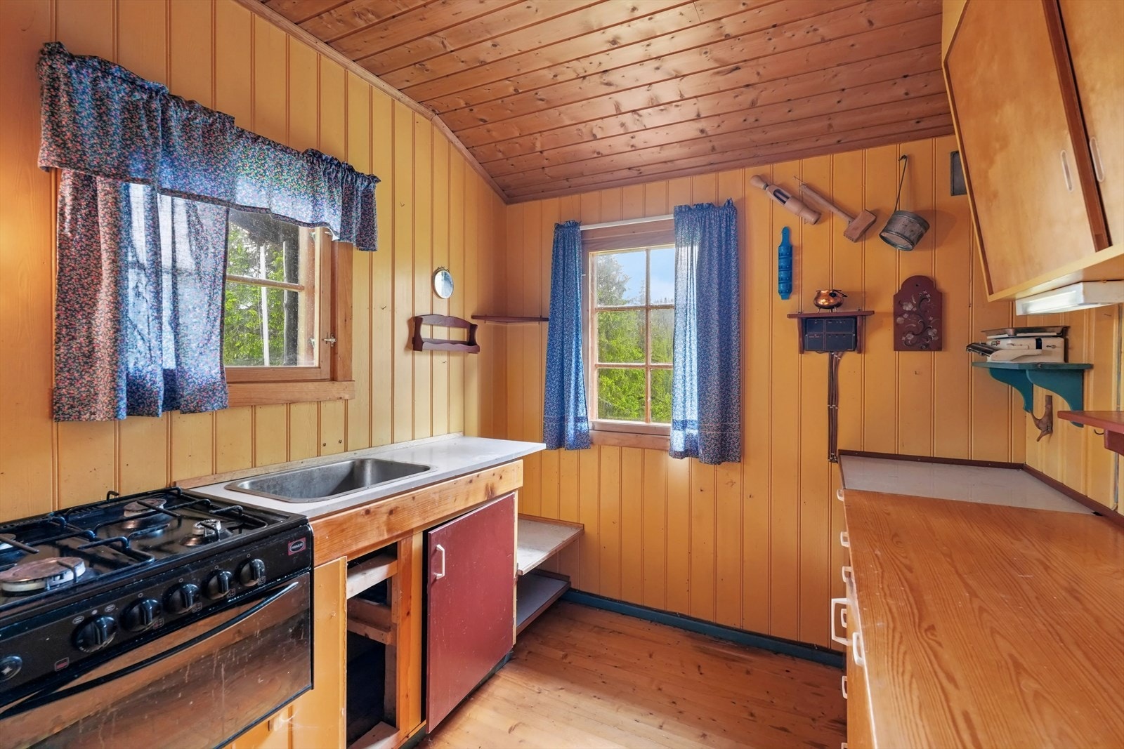 Kjøkkenet har en enkel, eldre innredning og er utstyrt med eldre gasskomfyr. Galleribilde