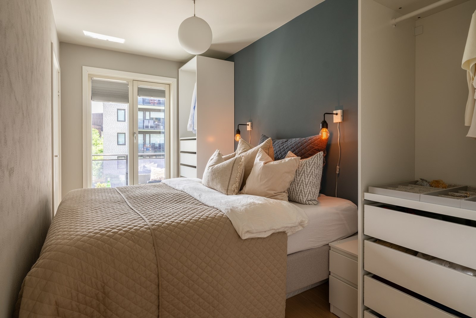 Leilighetens soverom har en god størrelse med plass til dobbeltseng og nattbord. Galleribilde