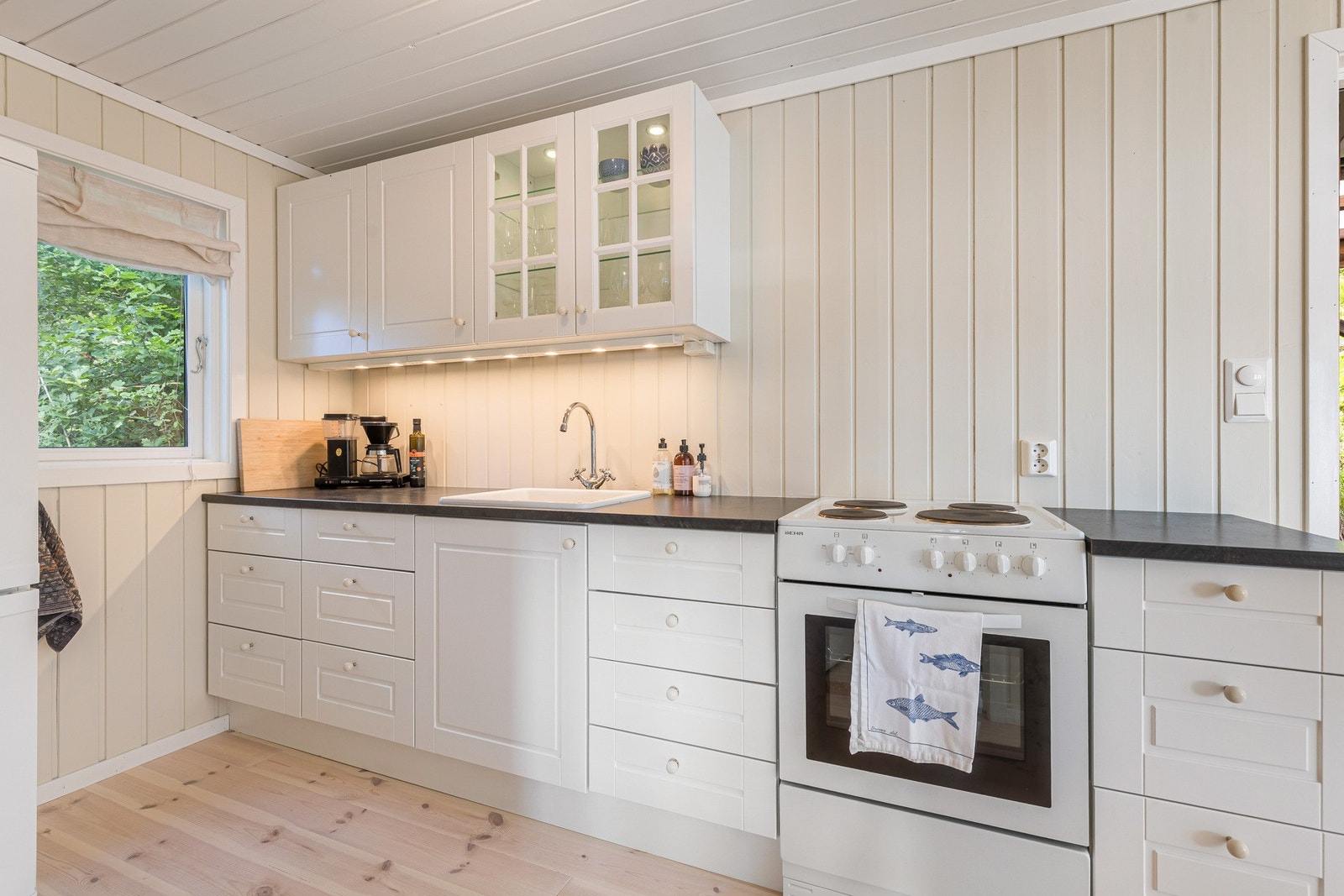 Det er belysning over benken, samt avsatt plass til komfyr og kjøleskap. Galleribilde