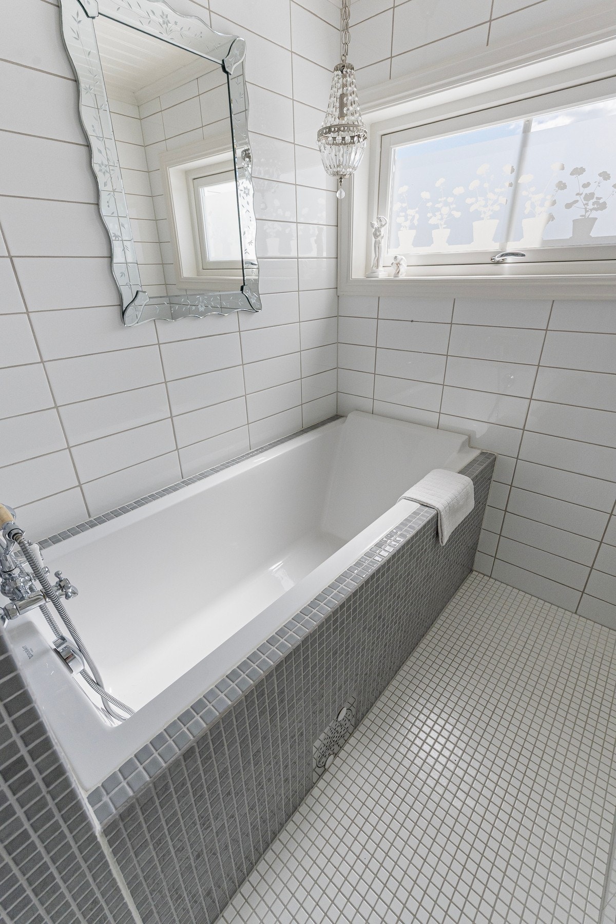 Innfliset badekar med dusj i tillegg til separat dusjnisje. Galleribilde