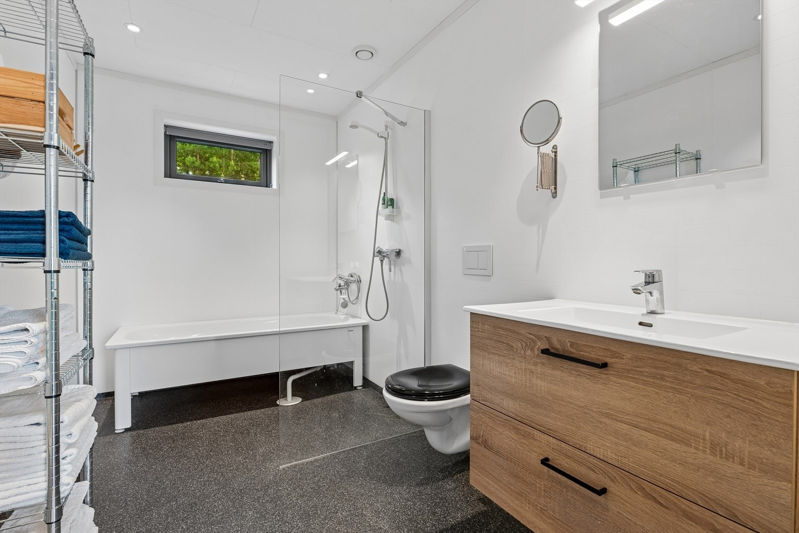 Badet har vinylbelegg med vannbåren gulvvarme, badekar og vegghengt toalett. Galleribilde