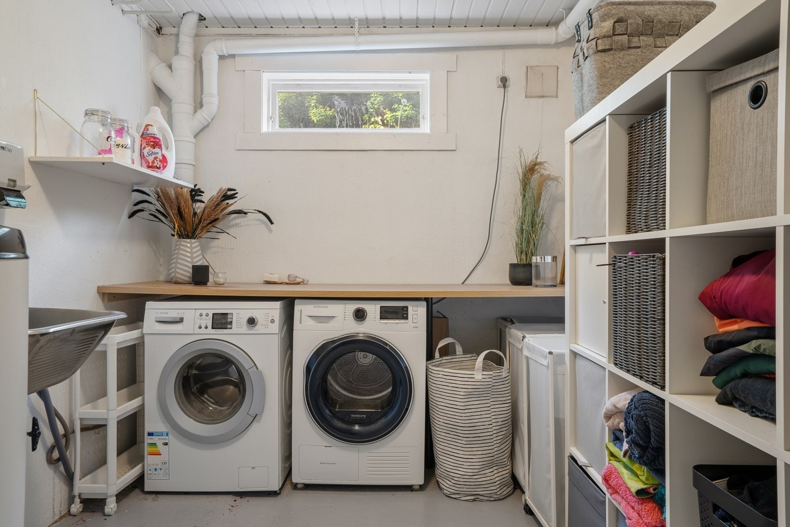 Praktisk vaskerom med opplegg for vaskemaskin/tørketrommel, utslagsvask i stål og gulvvarme. Galleribilde