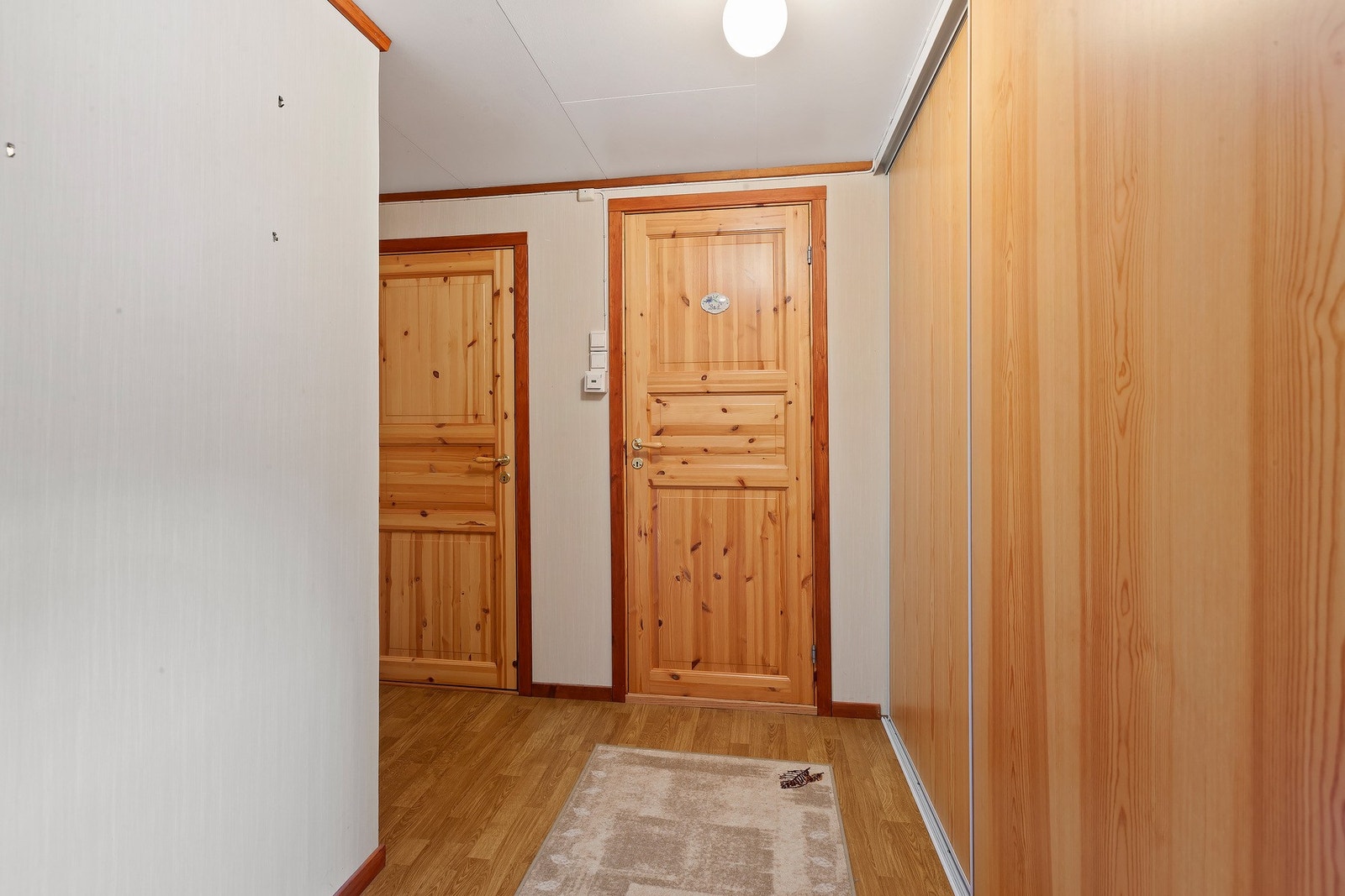 Den lyse gangen i andre etasje har en praktisk skyvedørsgarderobe som gir gode oppbevaringsmuligheter. Galleribilde