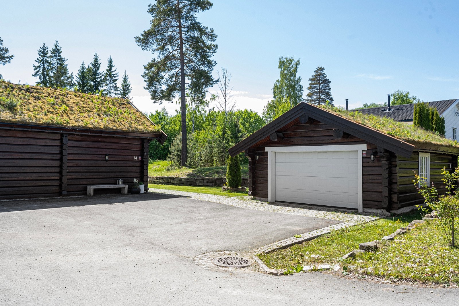 Den asfalterte og delvis steinlagte gårdsplassen gir et pent og ryddig førsteinntrykk. Galleribilde