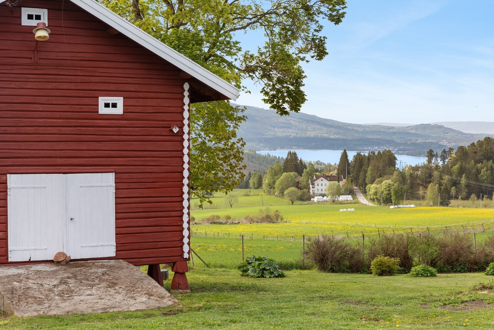 Fra tunet kan man nyte utsikten over åkerlandskapet og Randsfjorden. Galleribilde