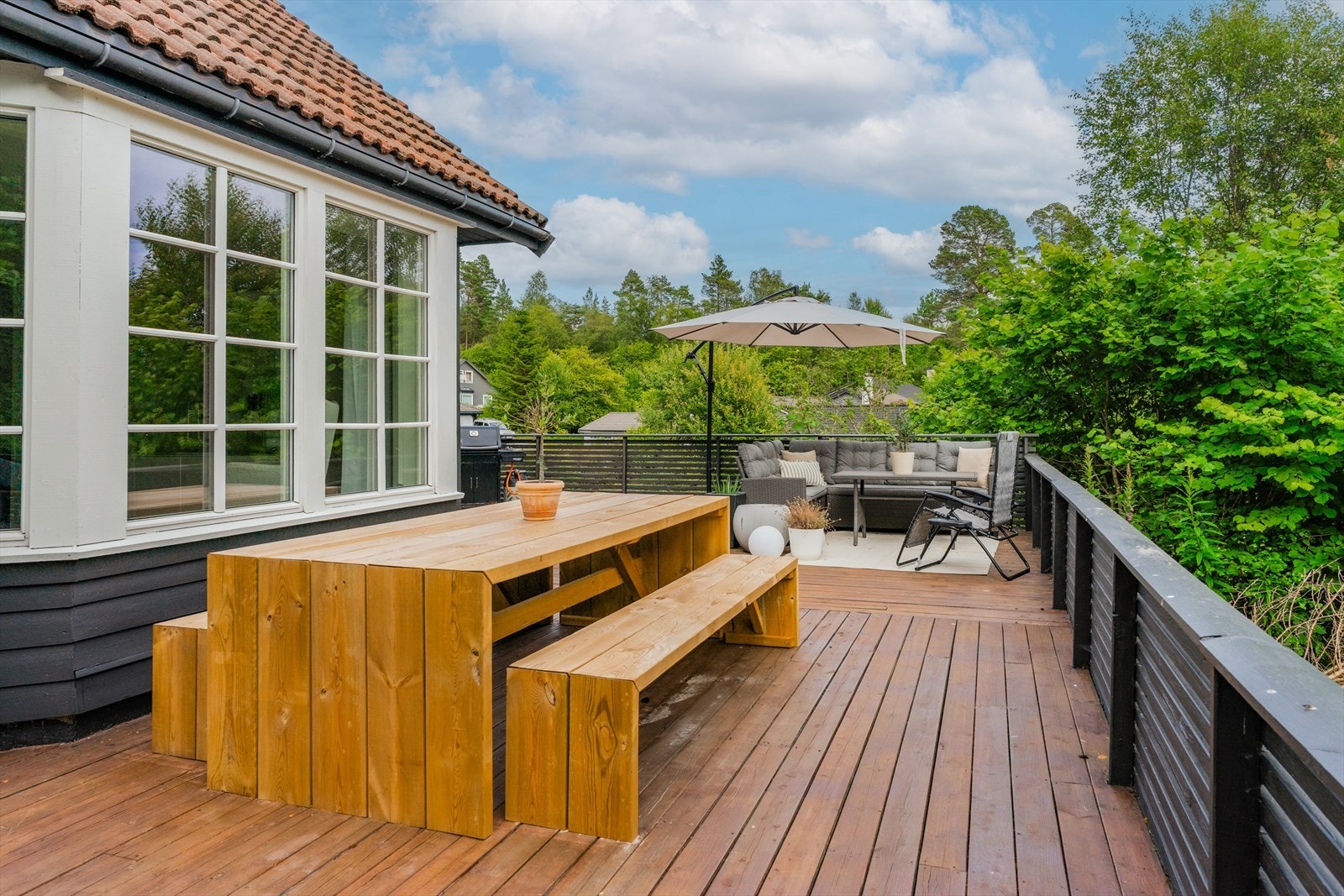 Fra stuen er det direkte utgang til en romslig og solrik terrasse som fungerer som en naturlig forlengelse av oppholdsrommet. Galleribilde