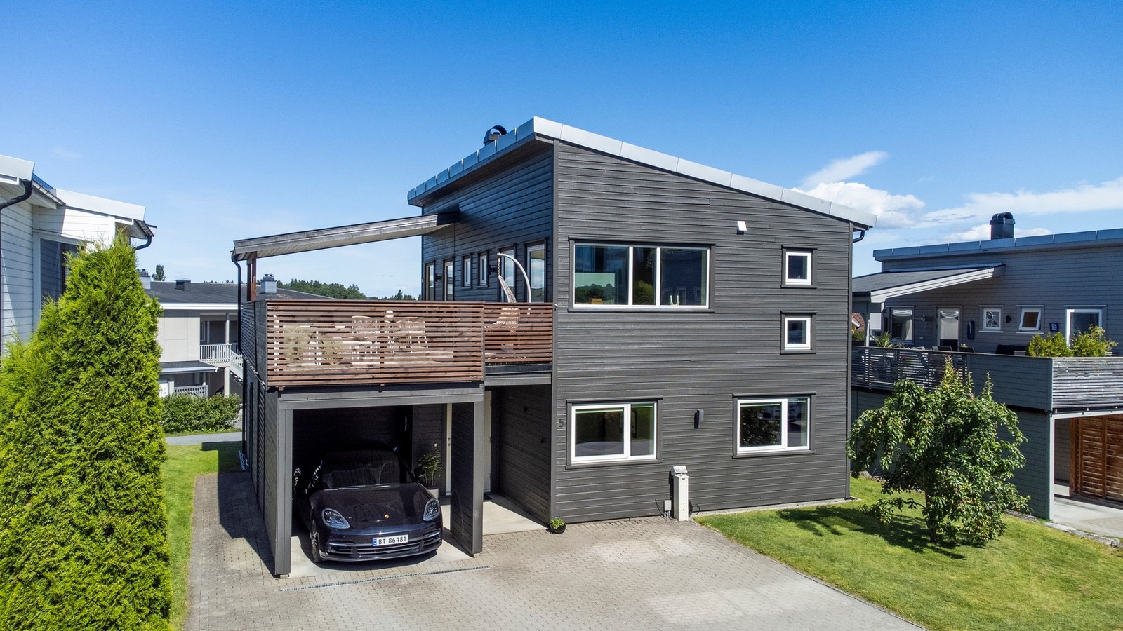Steinbelagt gårdsplass med god plass for flere biler, i tillegg til carport. Galleribilde