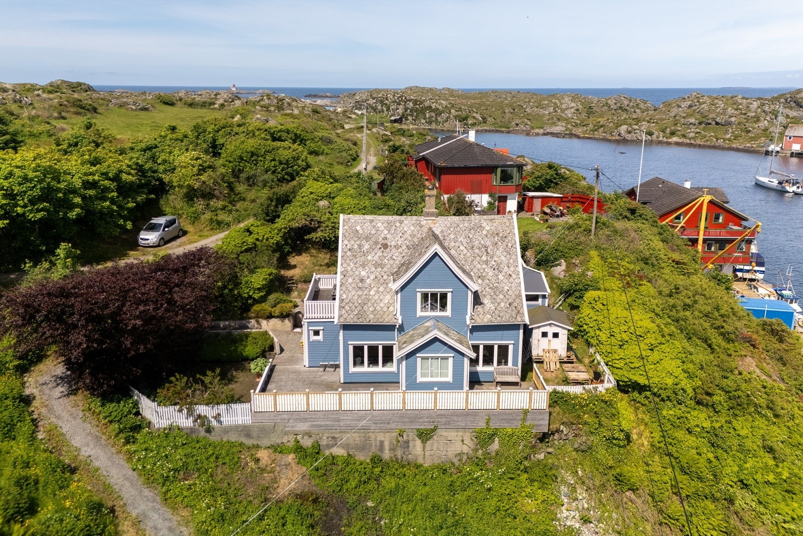 Eiendommen ligger vakkert til, omkranset av grønn natur og sjø. Galleribilde