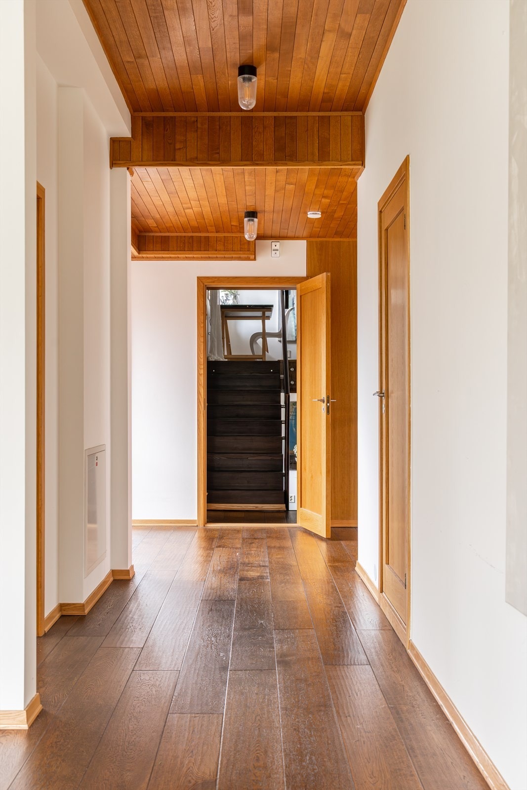 Designlampene som pryder stuen går igjen i 2. etasje og bidrar til en gjennomført stil i boligen. Den åpne døren leder inn til en fantastisk avdeling som presenteres nærmere på de kommende bilder. Galleribilde