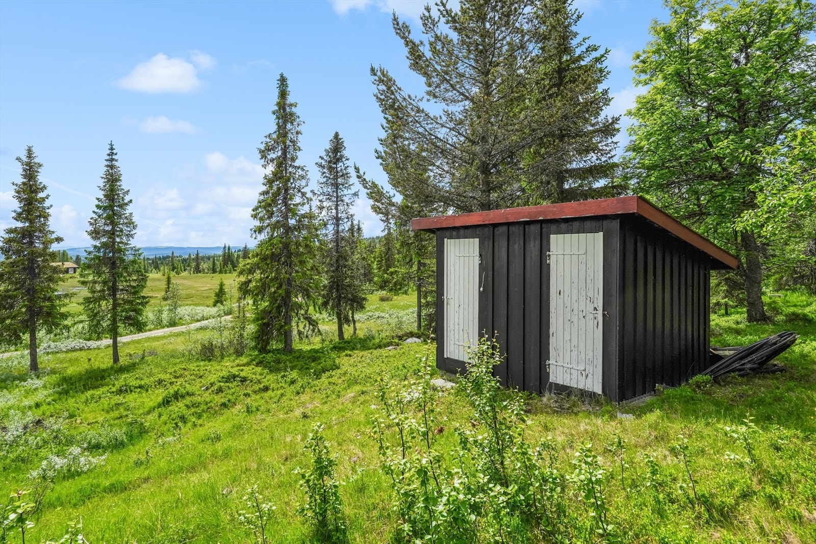 I Skogkanten står et uthus med boder og tidligere utedo. Bygningen gir gode oppbevaringsmuligheter for ved, ski, sykler, hagemøbler, redskap og annet turutstyr, og er et praktisk supplement til hytta. Galleribilde
