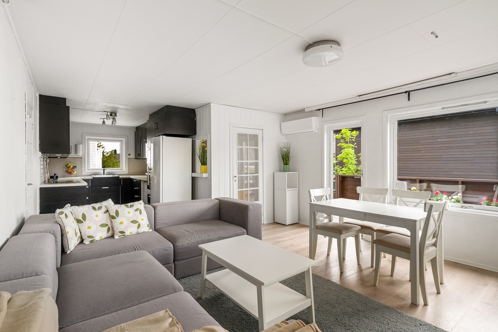 Oppholdsrommet har en praktisk planløsning med naturlige soner for både spisegruppe og sofakrok. Galleribilde