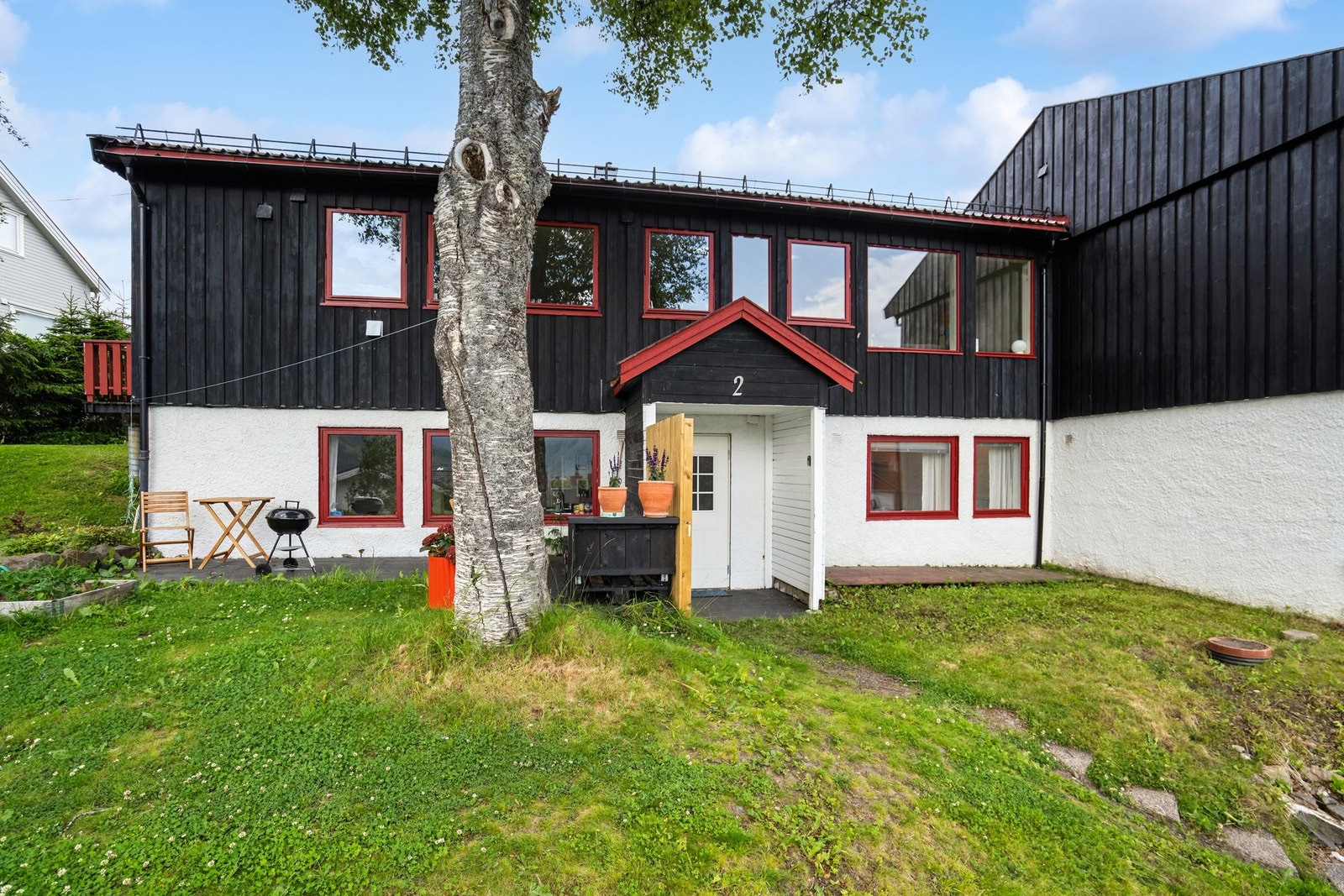 Leiligheten ligger i sokkeletasjen i en bygning fra 1975 med stående trepanel. Galleribilde