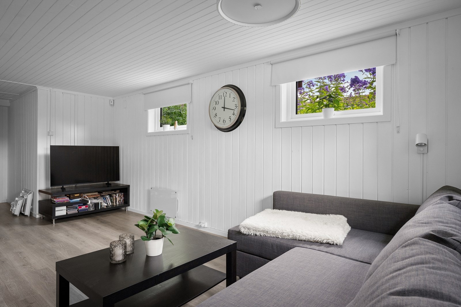 Kjellerstue med laminatgulv og panel på veggene. Galleribilde