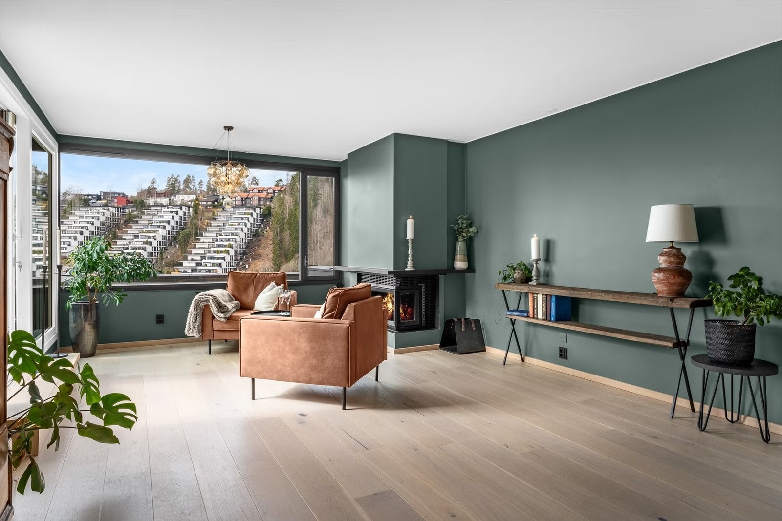 Romslig stue med store vindusflater som slipper naturen og utsikten helt inn Galleribilde