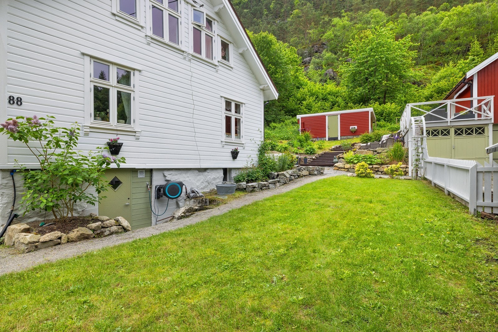 Oversiktlig og ryddig uteområde med godt samspill mellom plen, gangstier og beplantning. Galleribilde