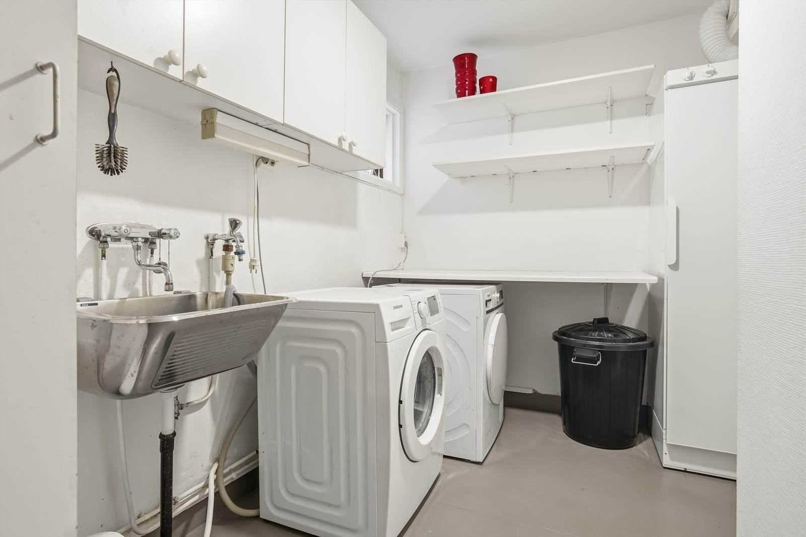 Eget vaskerom med stålskyllekar og opplegg for vaskemaskin. Galleribilde