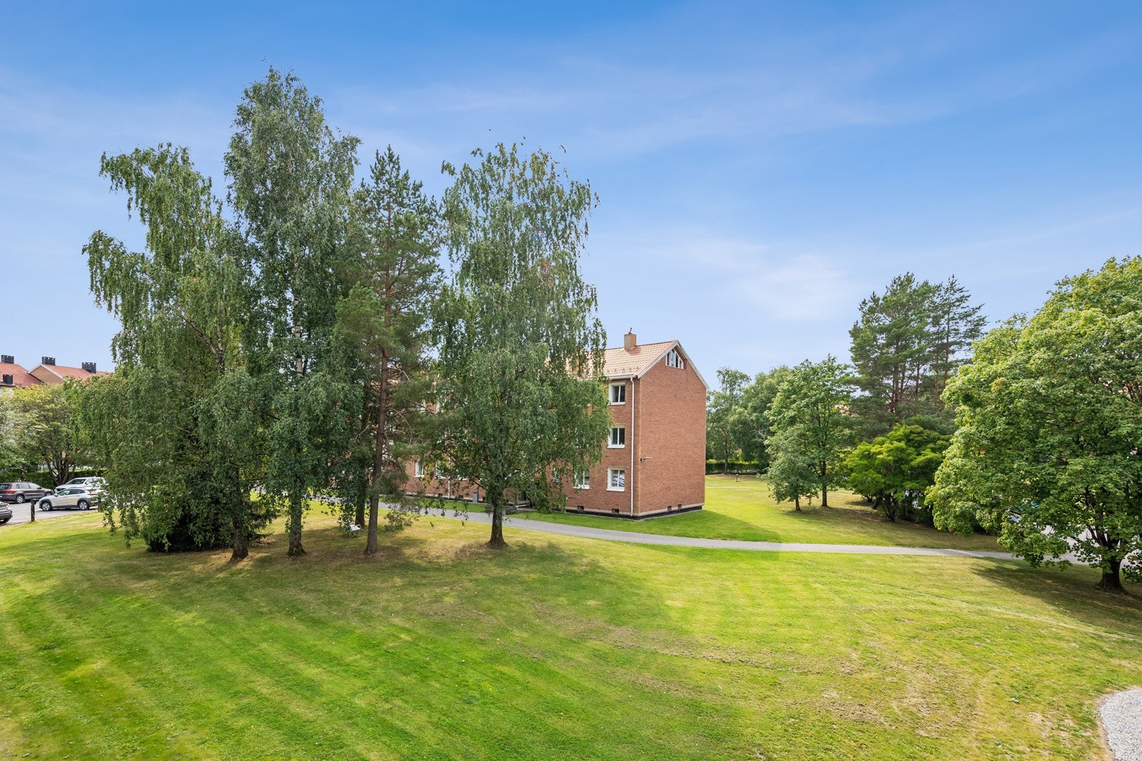 Utsikt fra balkongen og stuen over borettslagets grøntområder. Galleribilde