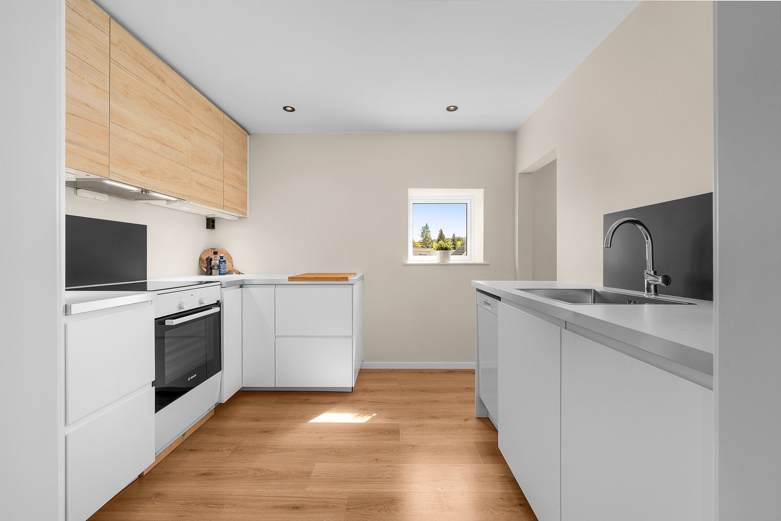 Ikea-kjøkken fra 2019/20 med innredning i glatte fronter, laminert benkeplate og hvitevarer Galleribilde