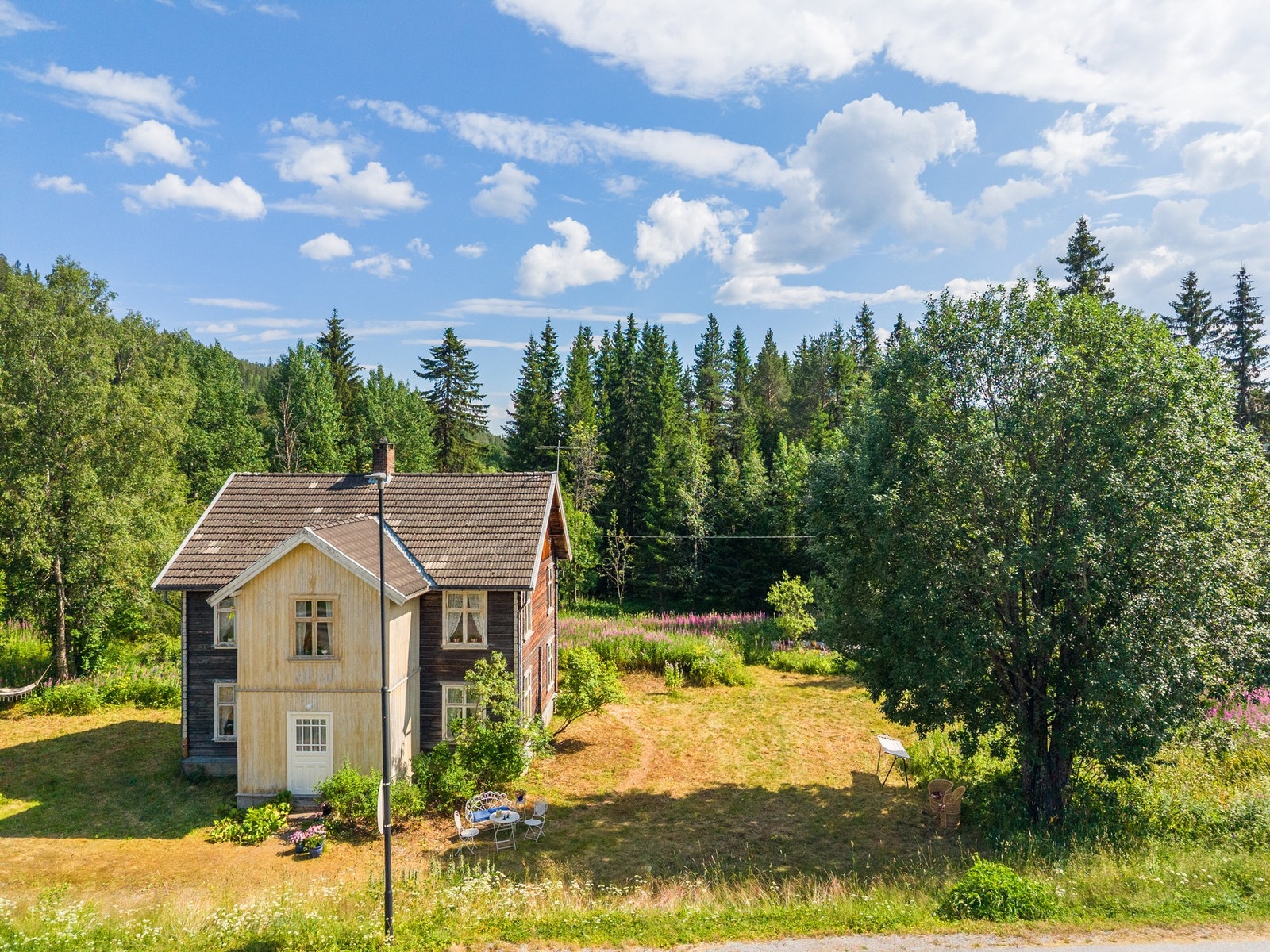 Eneboligen ligger på en romslig tomt med stort uteområde og god plass til lek, hage og hyggelige uteopphold. Galleribilde