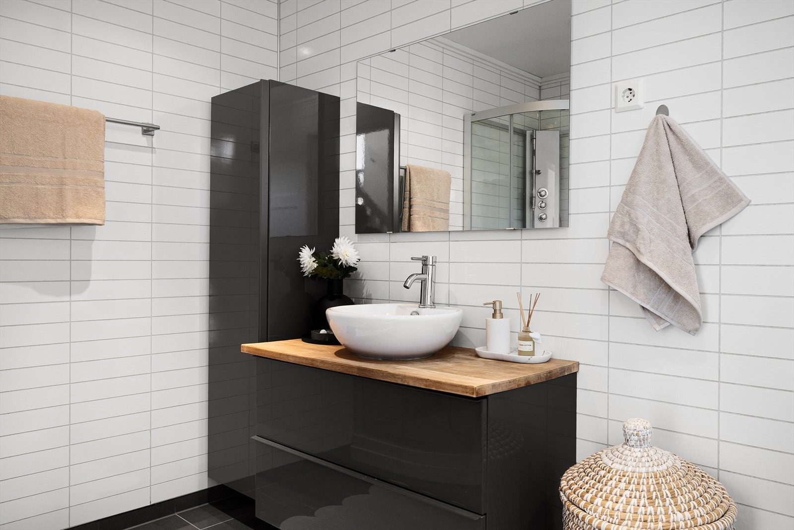 Badet med tilsvarende blanke fliser som i gangen og gir en god helhet. Delikat innredning og et skikkelig dusjkabinett. Galleribilde