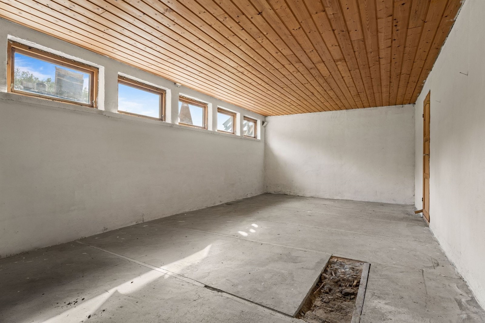 Kjelleren har betongvegger og -gulv, med stoppekran og varmtvannsbereder plassert her. Galleribilde