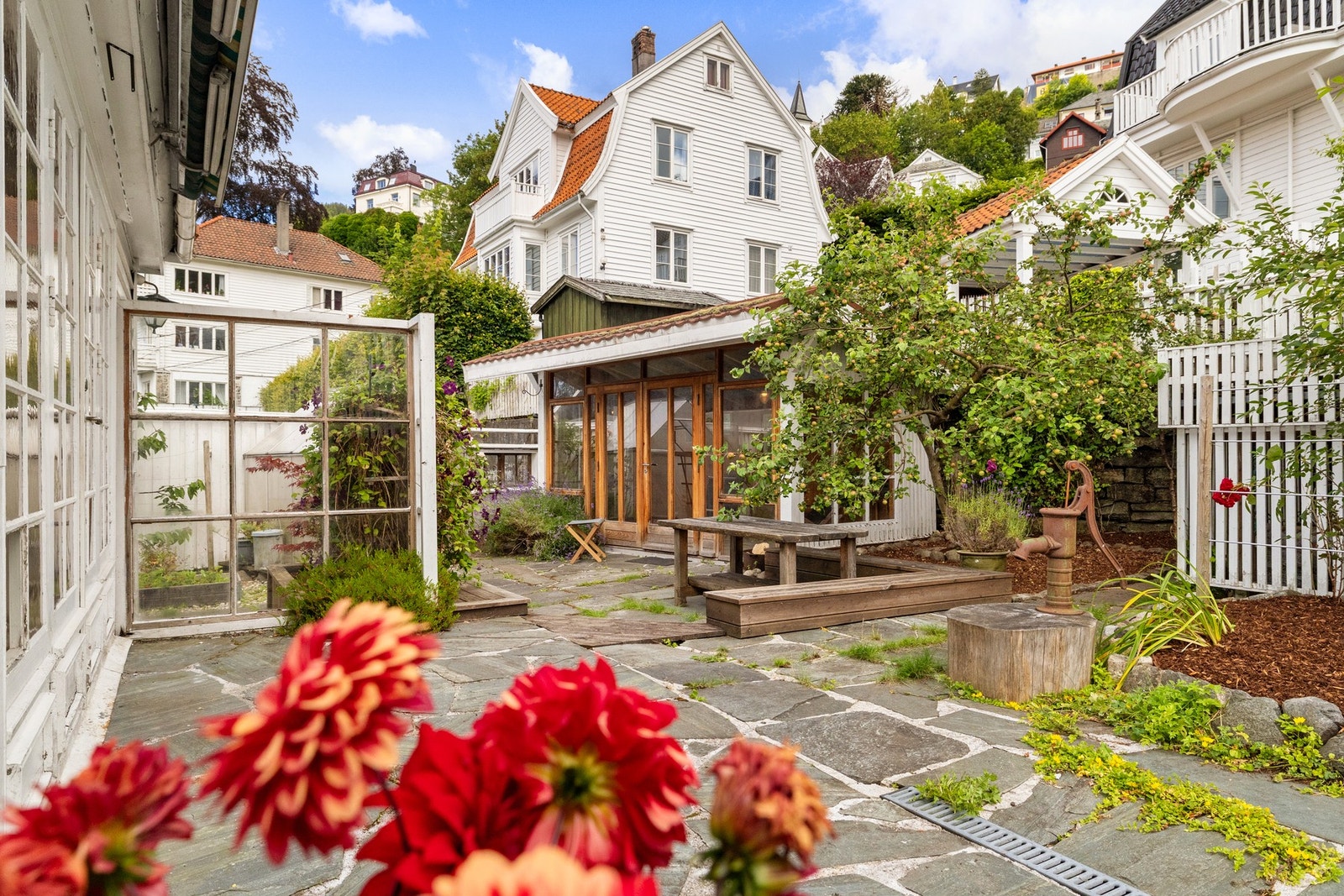 Den frodige hagen byr på epletre, plommetre og to kirsebærtrær som både gir vakker blomstring og frukt gjennom sesongen. Galleribilde