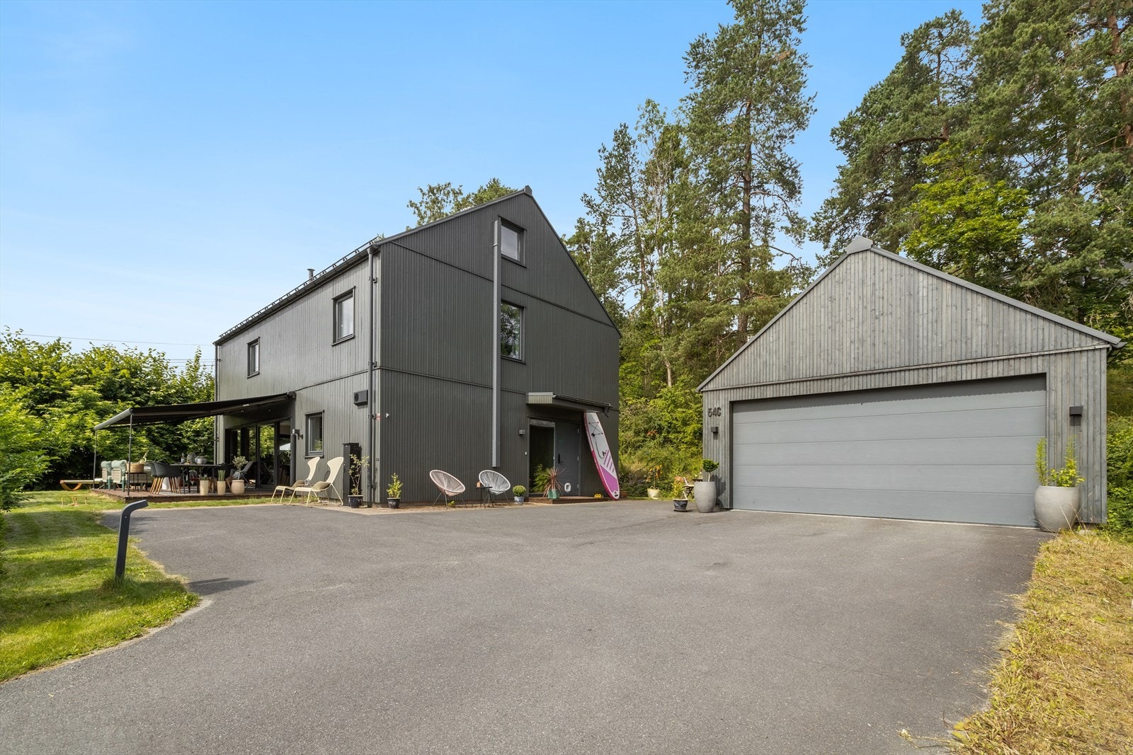Frittstående dobbelgarasje med god oppbevaringsplass og elbillader. I tillegg er det en romslig asfaltert innkjøring med svært gode parkeringsmuligheter på egen eiendom Galleribilde