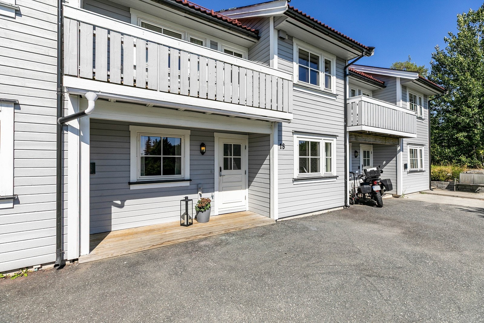 Lader til EL-bil er montert på husveggen ved inngangspartiet. Galleribilde