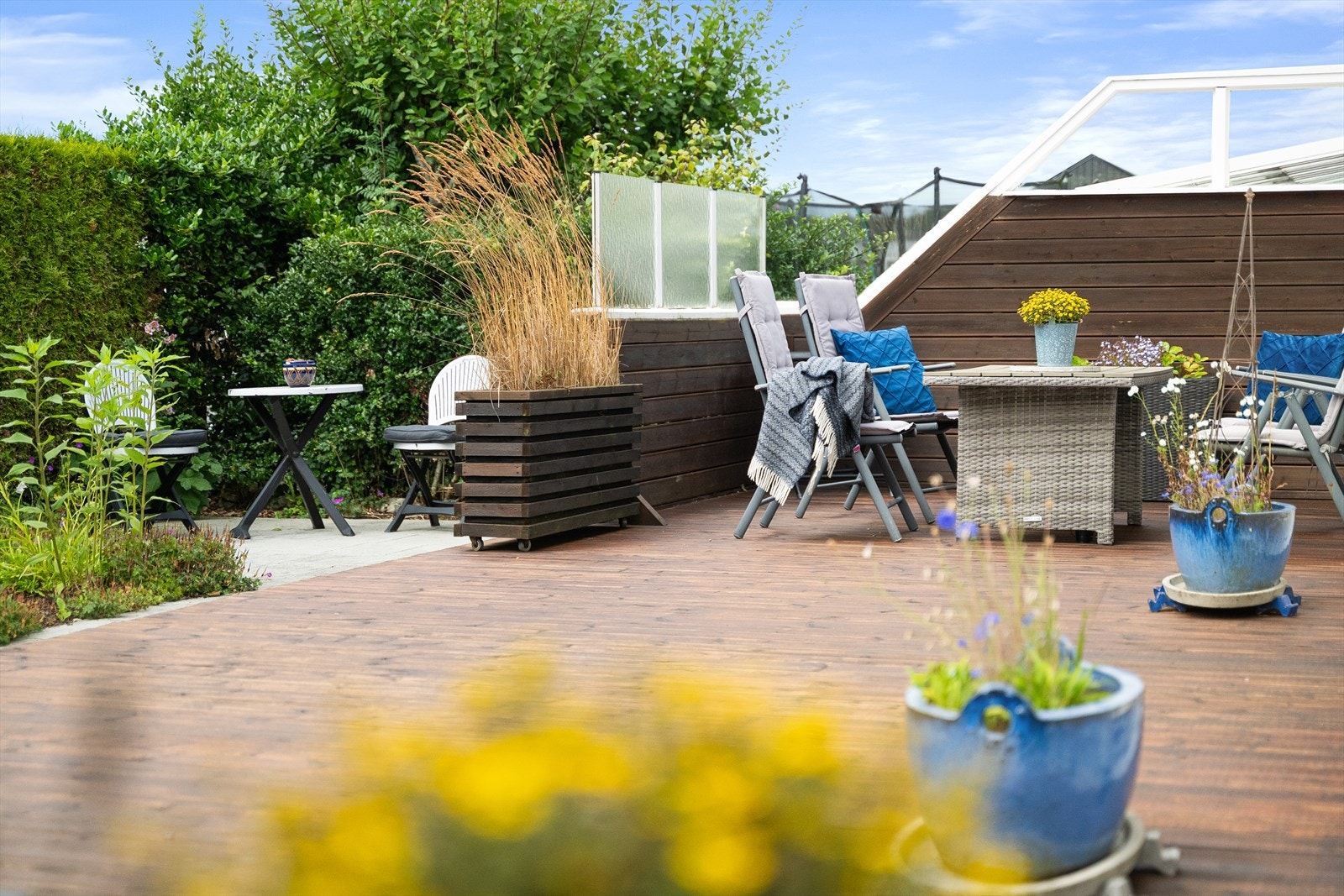 Uteområdet kombinerer en stor treterrasse med plattinger av strukturbetong. Galleribilde