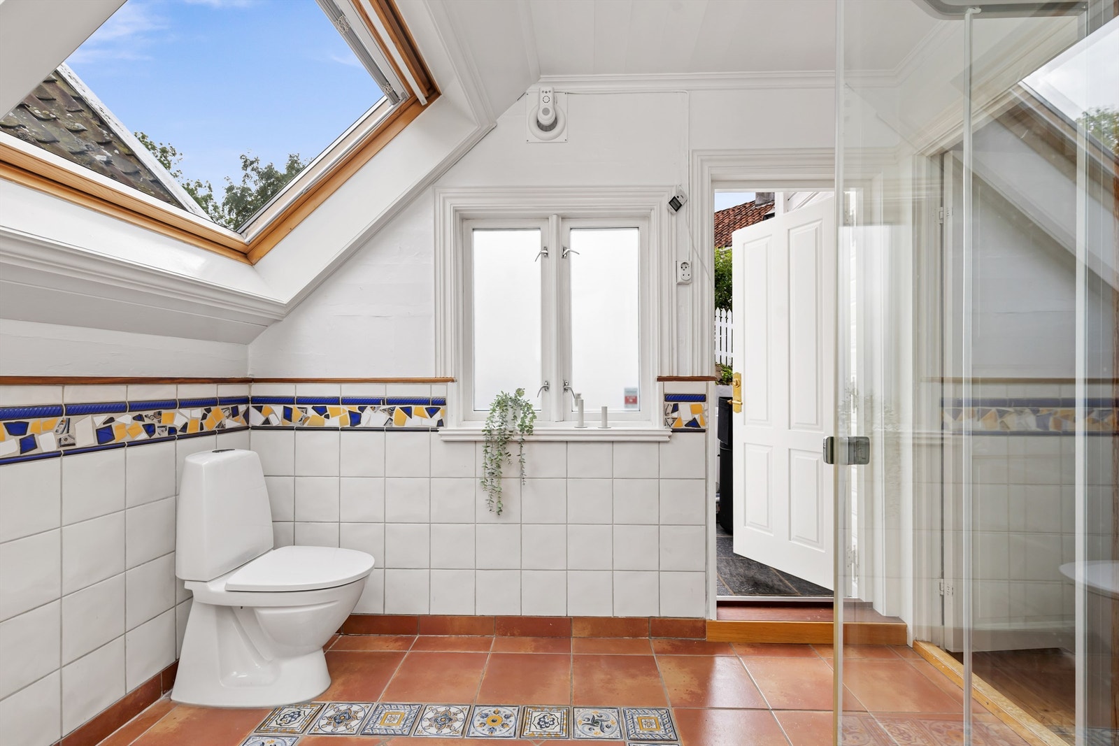 Takvinduer gir rikelig med dagslys og en luftig følelse. Her er det også utgang til boligens bakside med terrasse og hage. Galleribilde