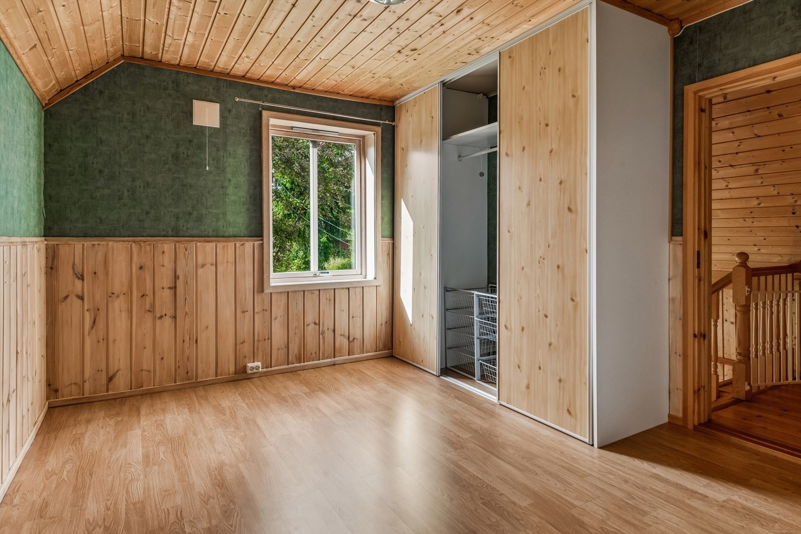 Oppe i 2. etasje er en gang og to soverom. Dette soverommet har skyvedørsgarderobe. Galleribilde