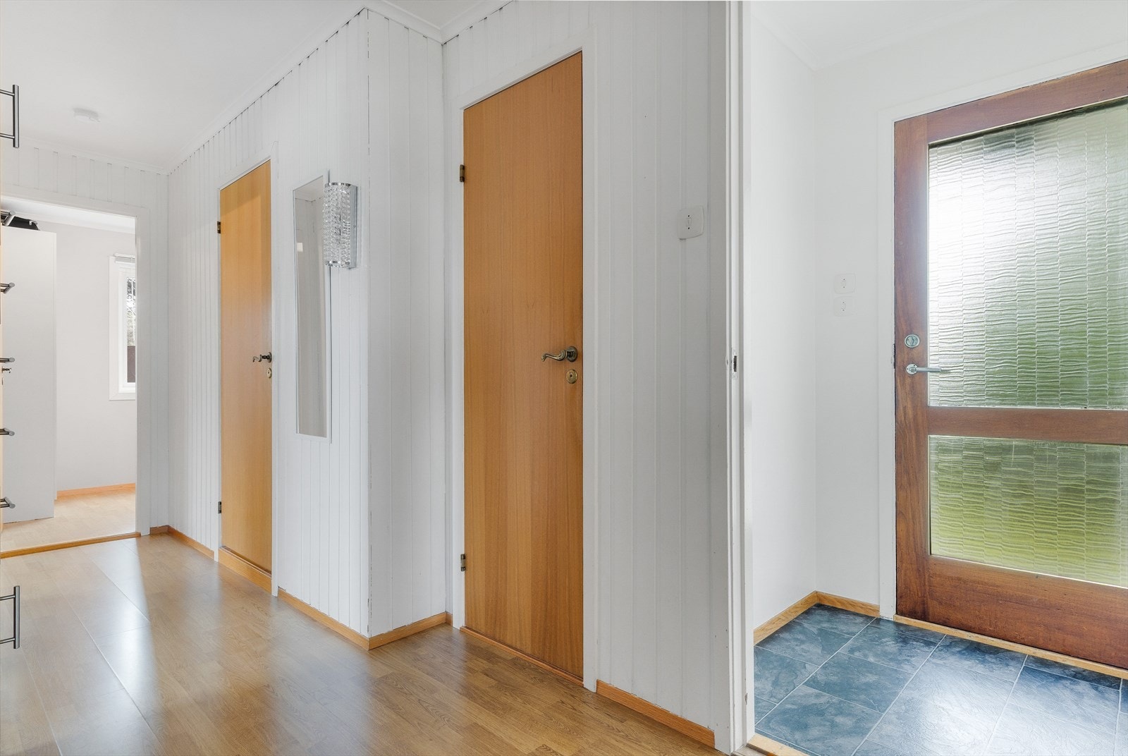 Lys entré og gang med god plass til oppbevaring av yttertøy og sko. Galleribilde
