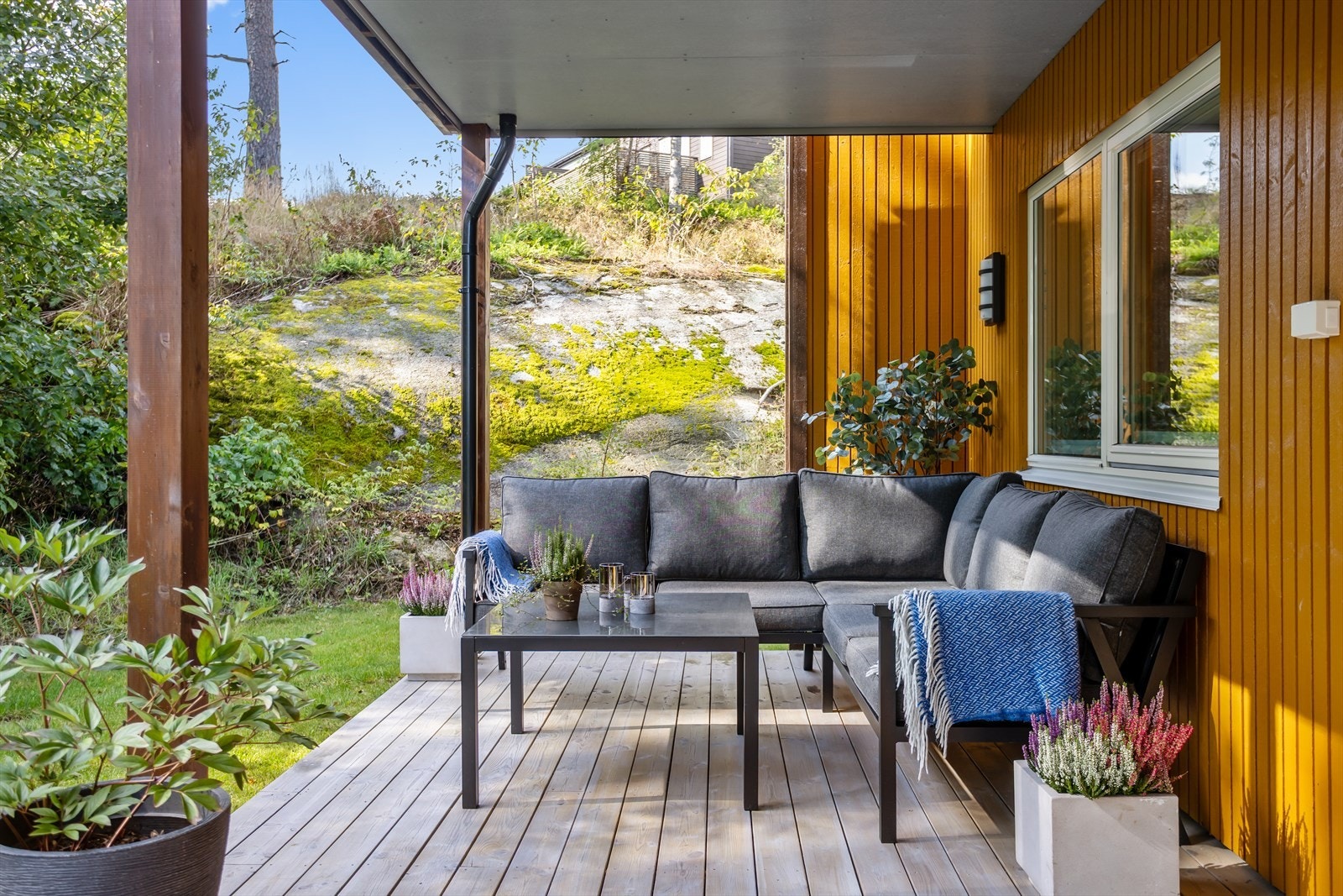 Terrassen har dekke i tre, og det er montert utebelysning på veggen Galleribilde