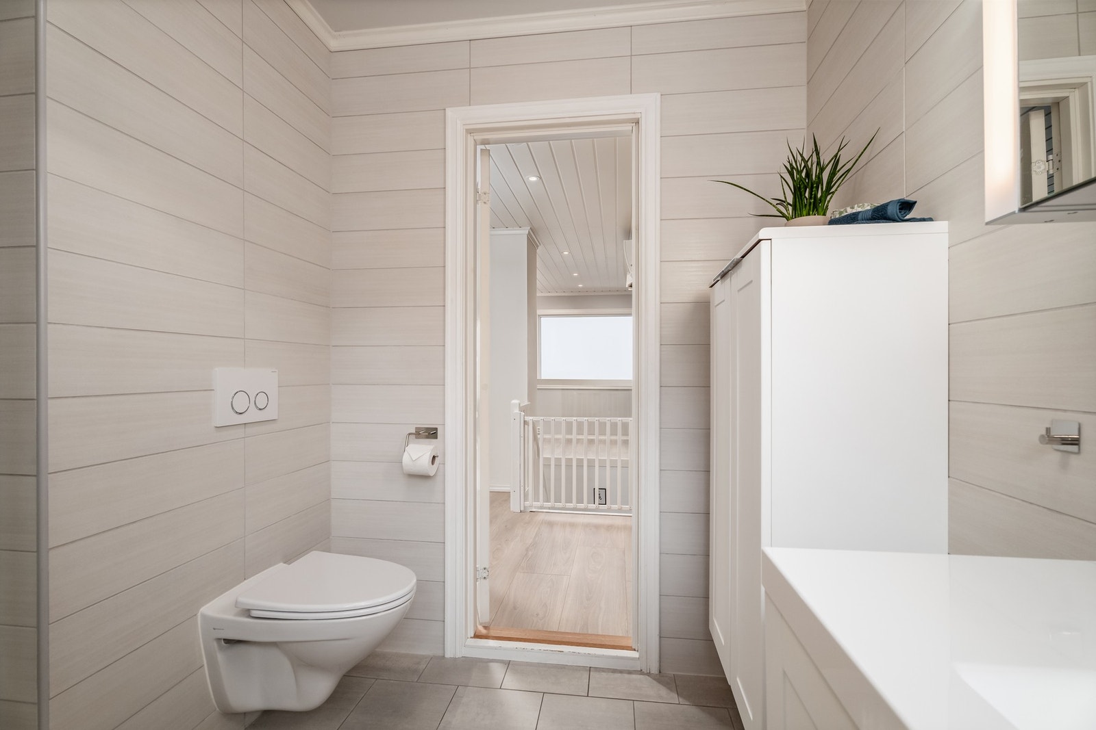 Badet har godt med oppbevaring under servant og vegghengt skap. Galleribilde