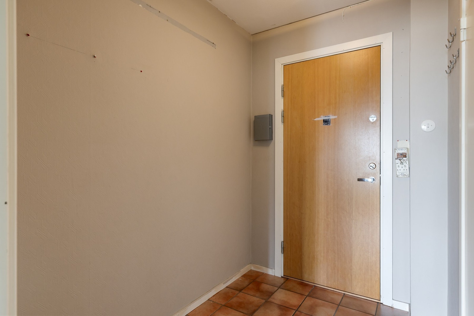 Flislagt entré med adkomst til boligens øvrige rom. Galleribilde