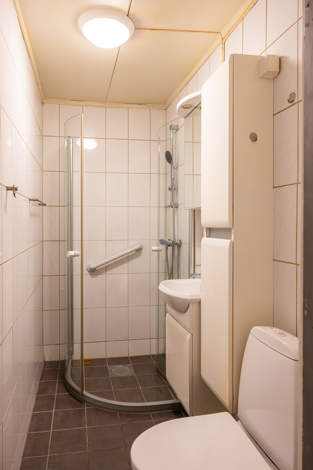 Flislagt bad med gulvvarme og svingbare dusjvegger. Galleribilde