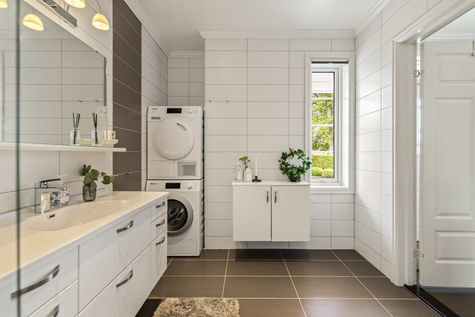 Badet er fra 2011 og har flislagt gulv med varmekabler samt downlights i himlingen. R
ommet er innredet med vegghengt toalett, badekar med dusjløsning og vegghengt servantinnredning med nedfelt servant og speil. Galleribilde