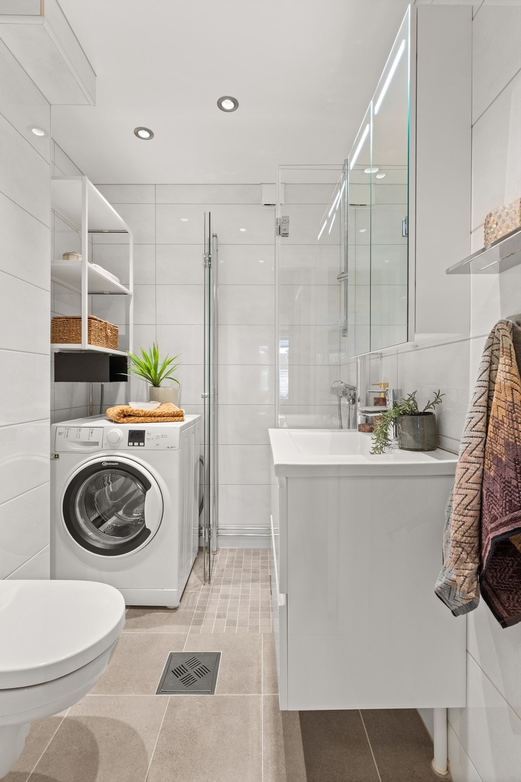 Flislagt bad oppusset i 2019 med moderne materialvalg og varmekabler i gulvet. Det er opplegg for vaskemaskin, og vaskemaskin medfølger. Galleribilde