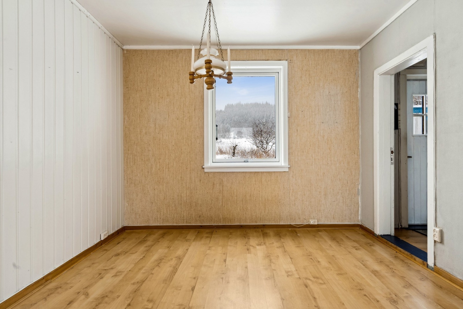 Overflater med trepanel og strie på veggene, og parkett på gulvet. Galleribilde