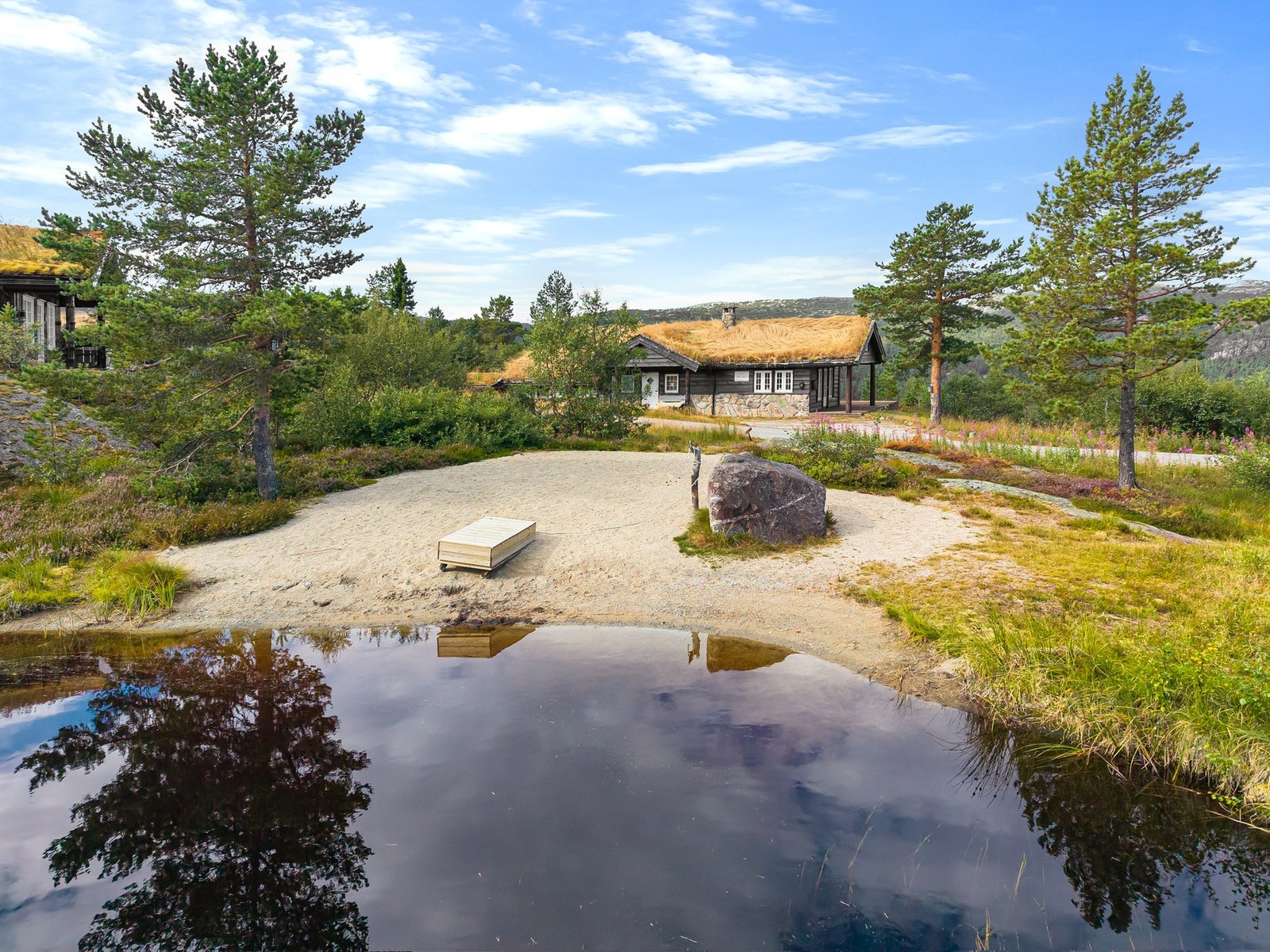 Lite tjern med sandstrand like ved Galleribilde