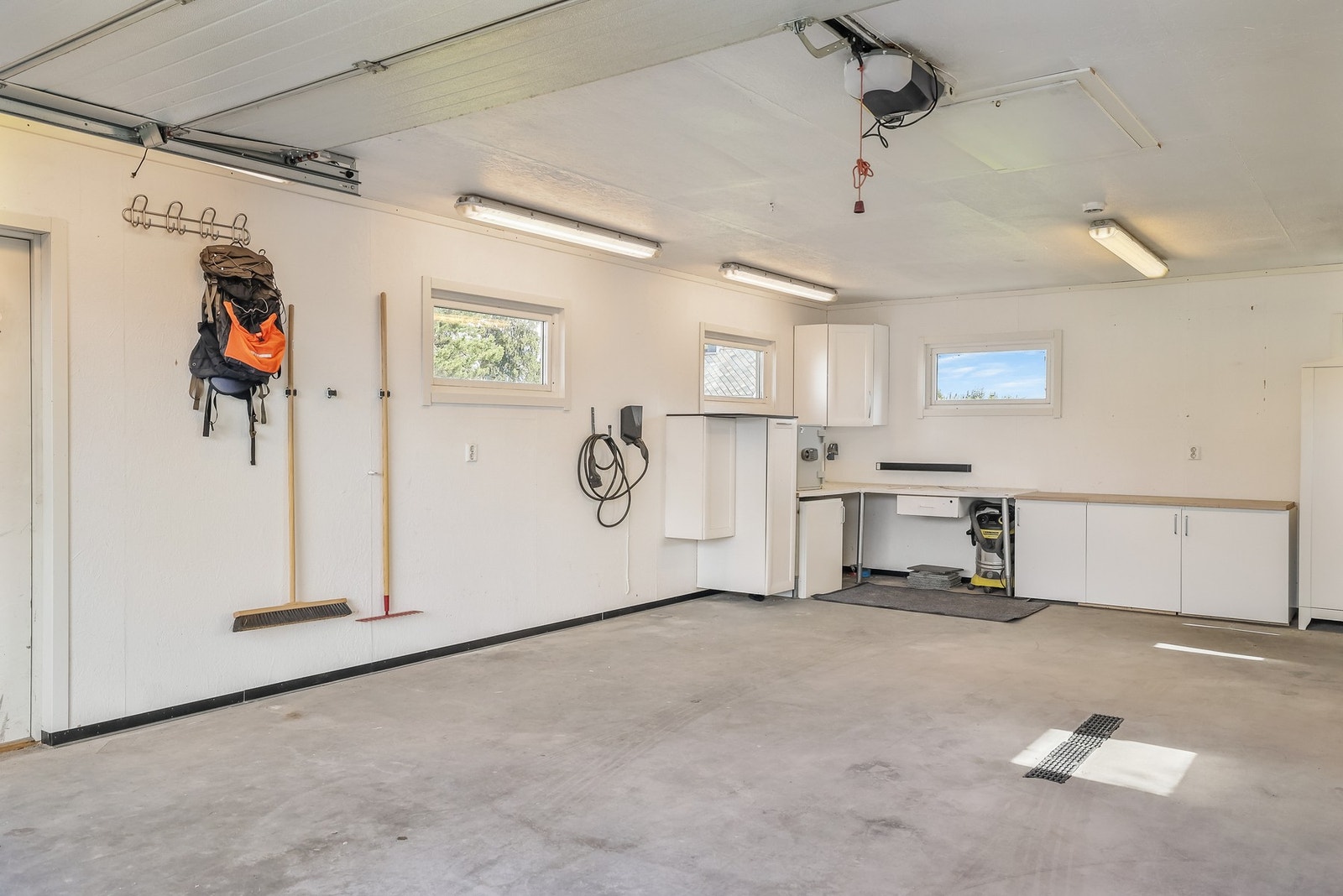 Romslig dobbelgarasje med god plass til lagring og verkstedbenk. Galleribilde