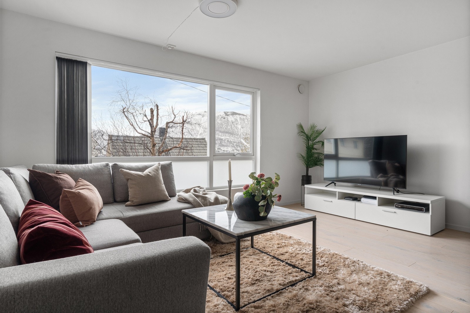 Sofagruppen har sin naturlige plass i hjørnet, med plass til TV mot motsatt vegg.