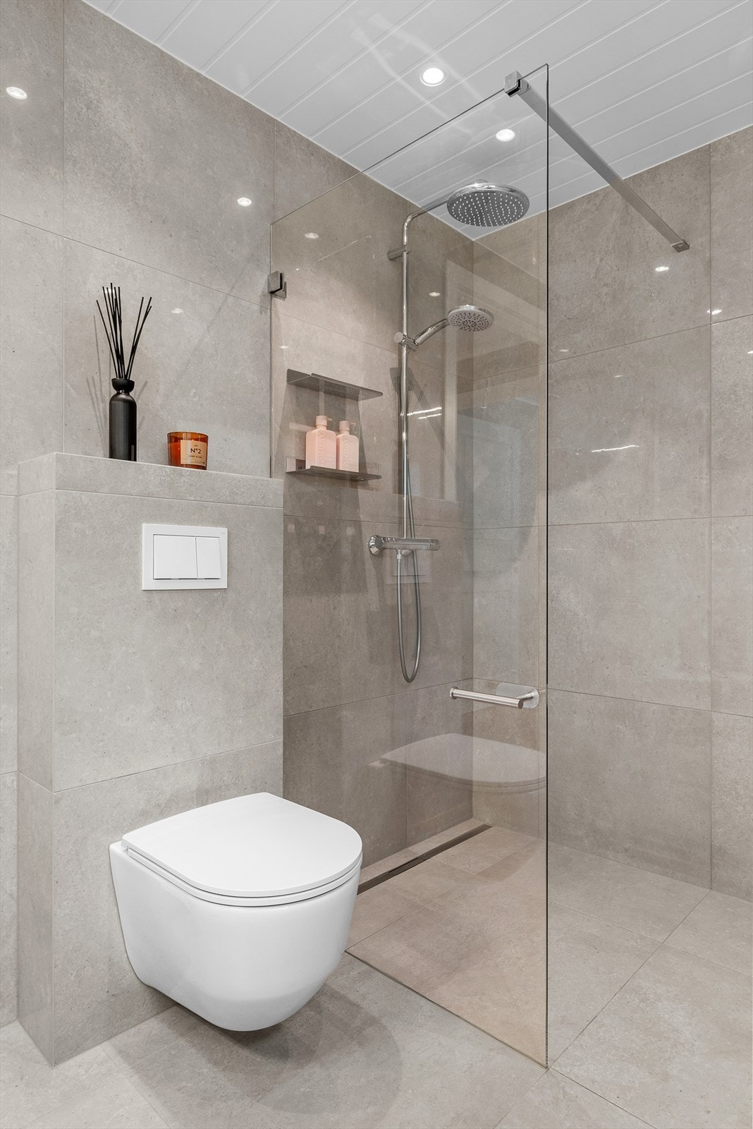Badet går over 6,5 kvm og er utstyrt med glassvegg, servantskap, wc og mekanisk avtrekk. Galleribilde