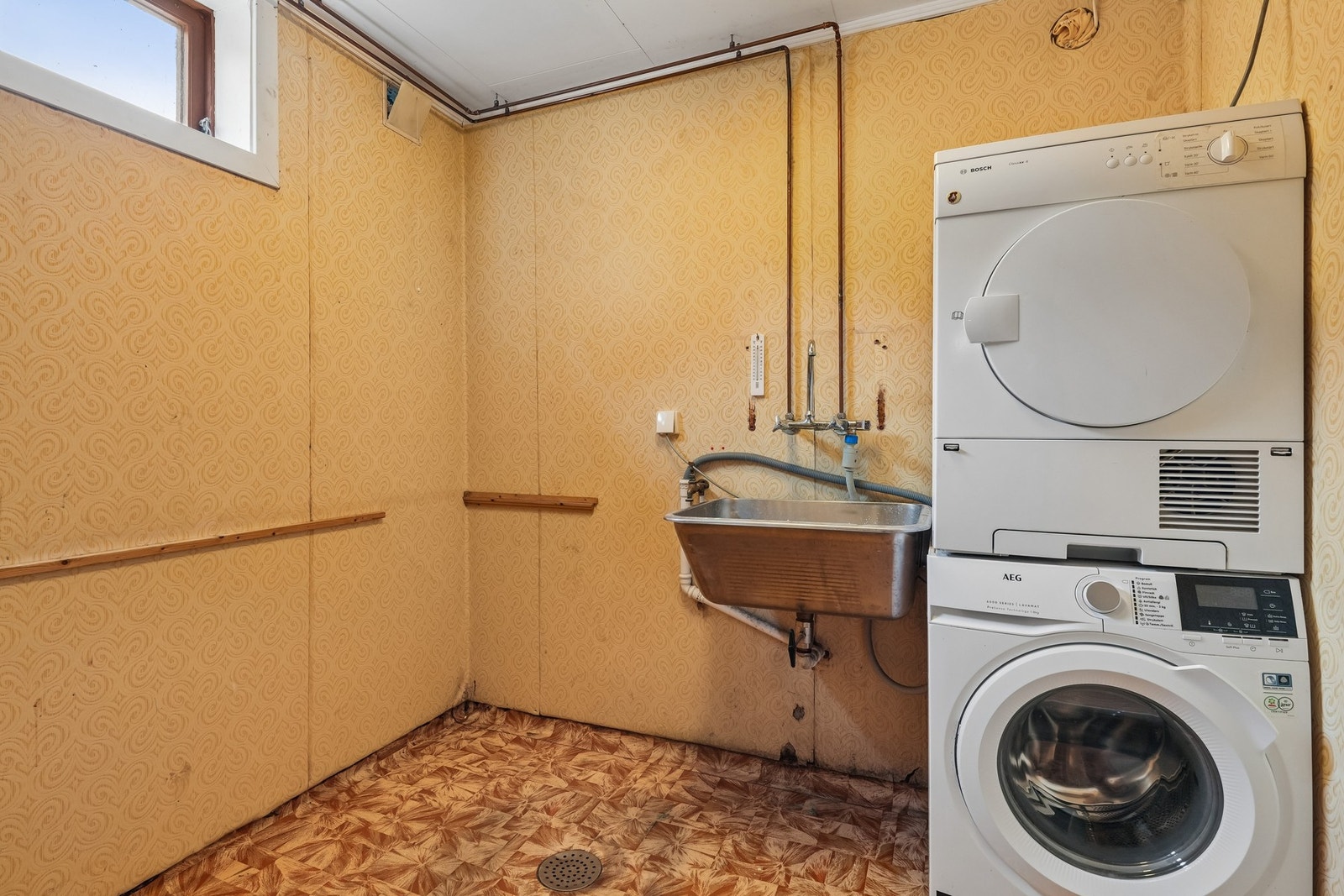 I kjelleretasjen finnes også et vaskerom med opplegg for vaskemaskin. Rommet har behov for renovering Galleribilde