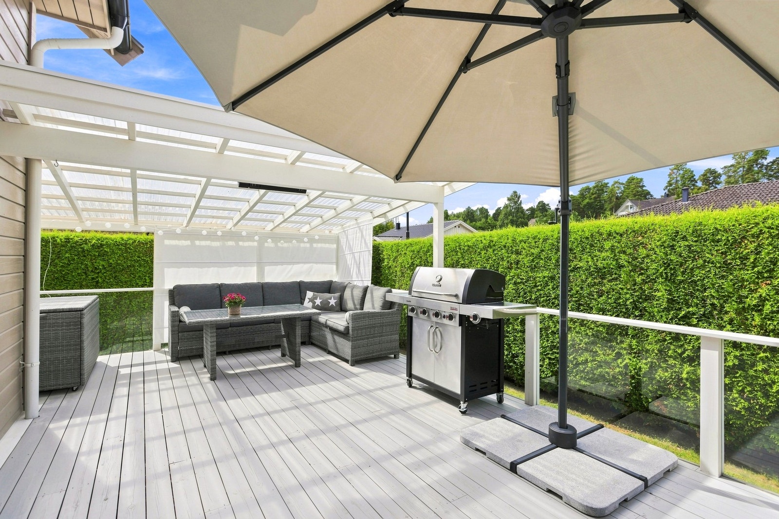 Skjermet og solrik terrasse med takoverbygg. Galleribilde