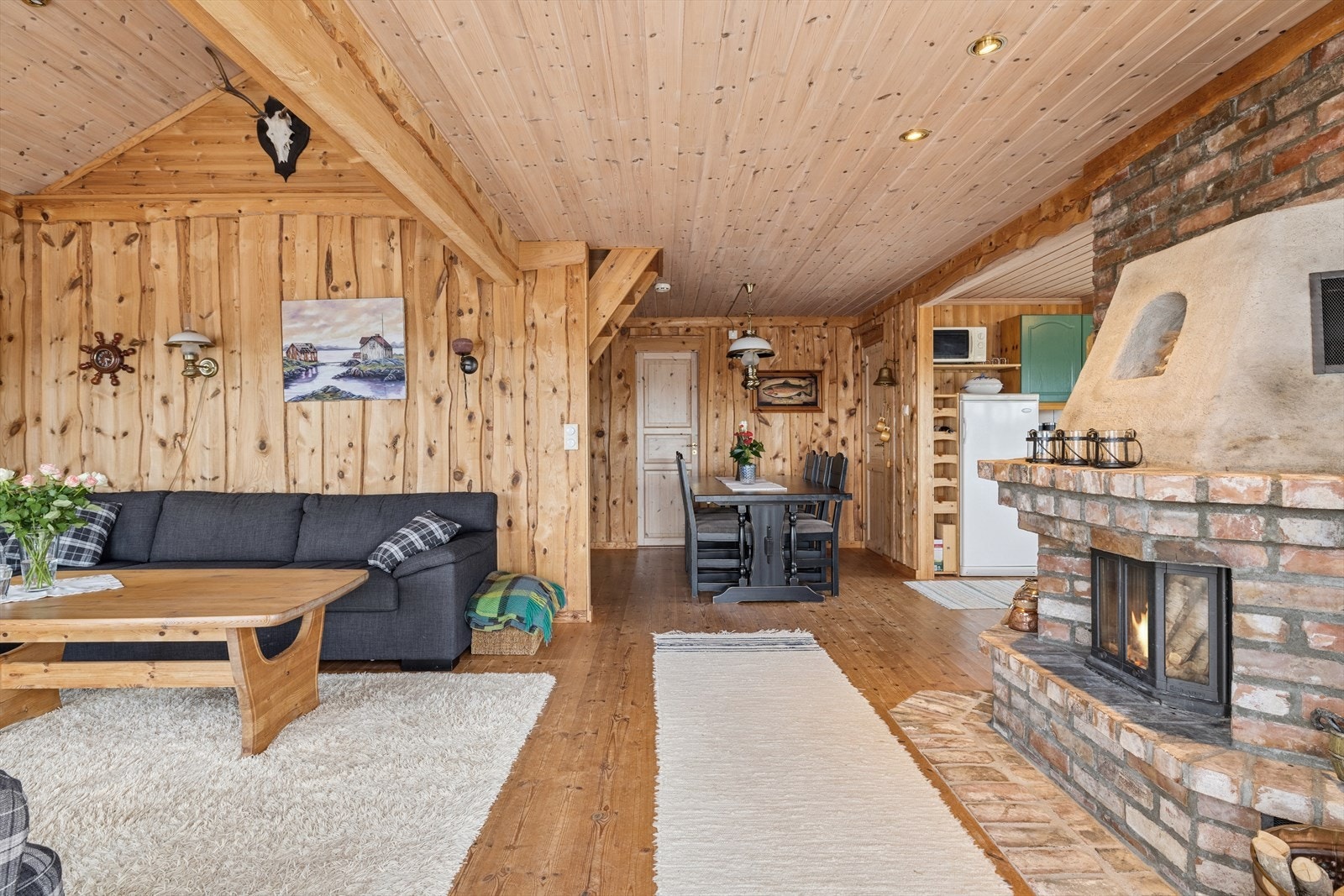 Stuen har god plass til både sofa- og spisegruppe. Koselig peis som skaper en hyggelig atmosfære Galleribilde