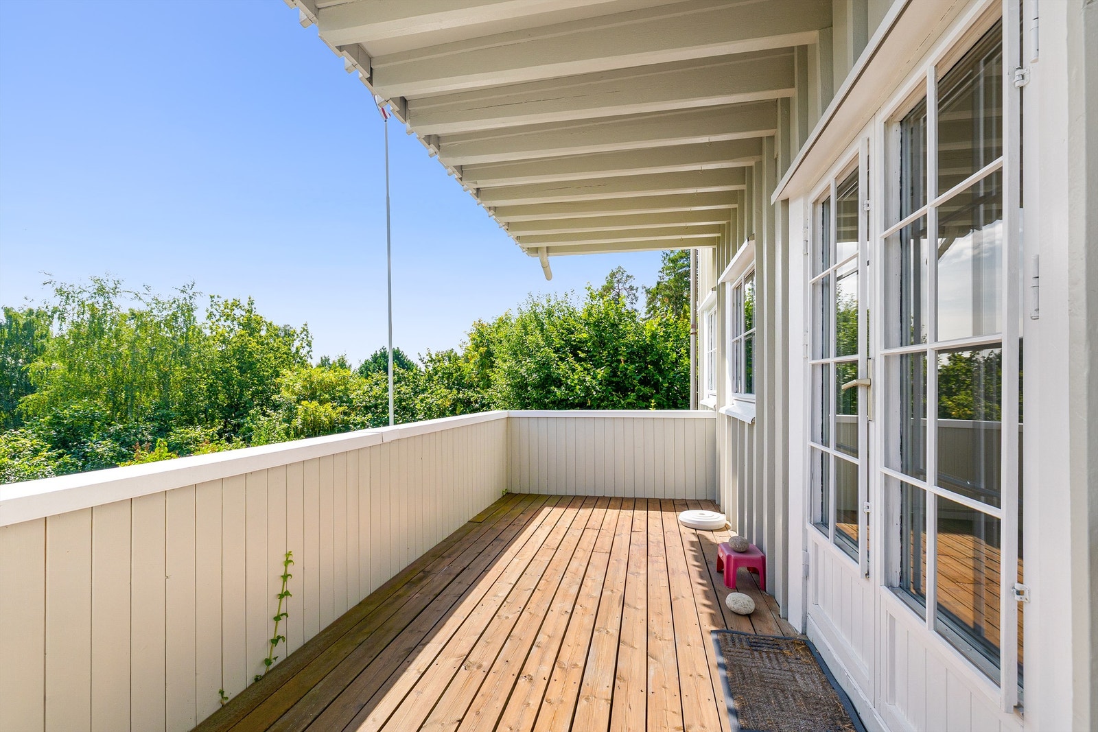 Sydøstvendt balkong på 11 m² med terrassebord og rekkverk i tre. Galleribilde
