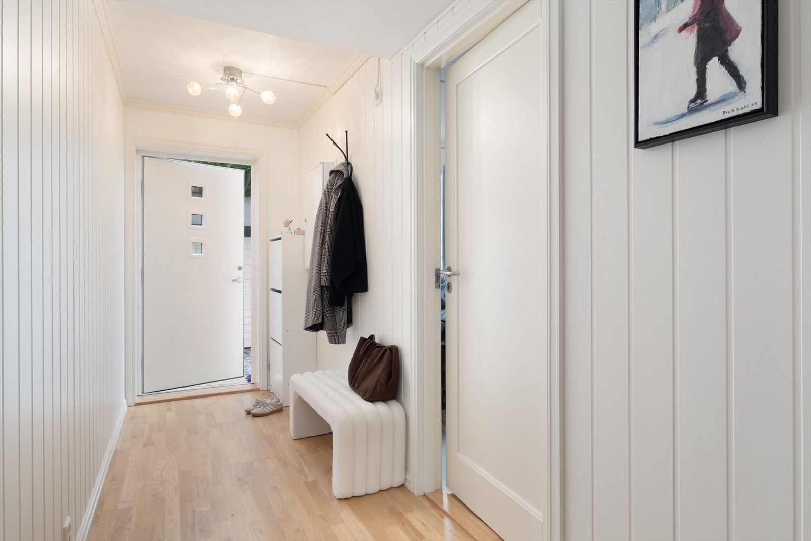 Lys og triveleg entré med plass til garderobe og oppheng for ytterkle. Galleribilde