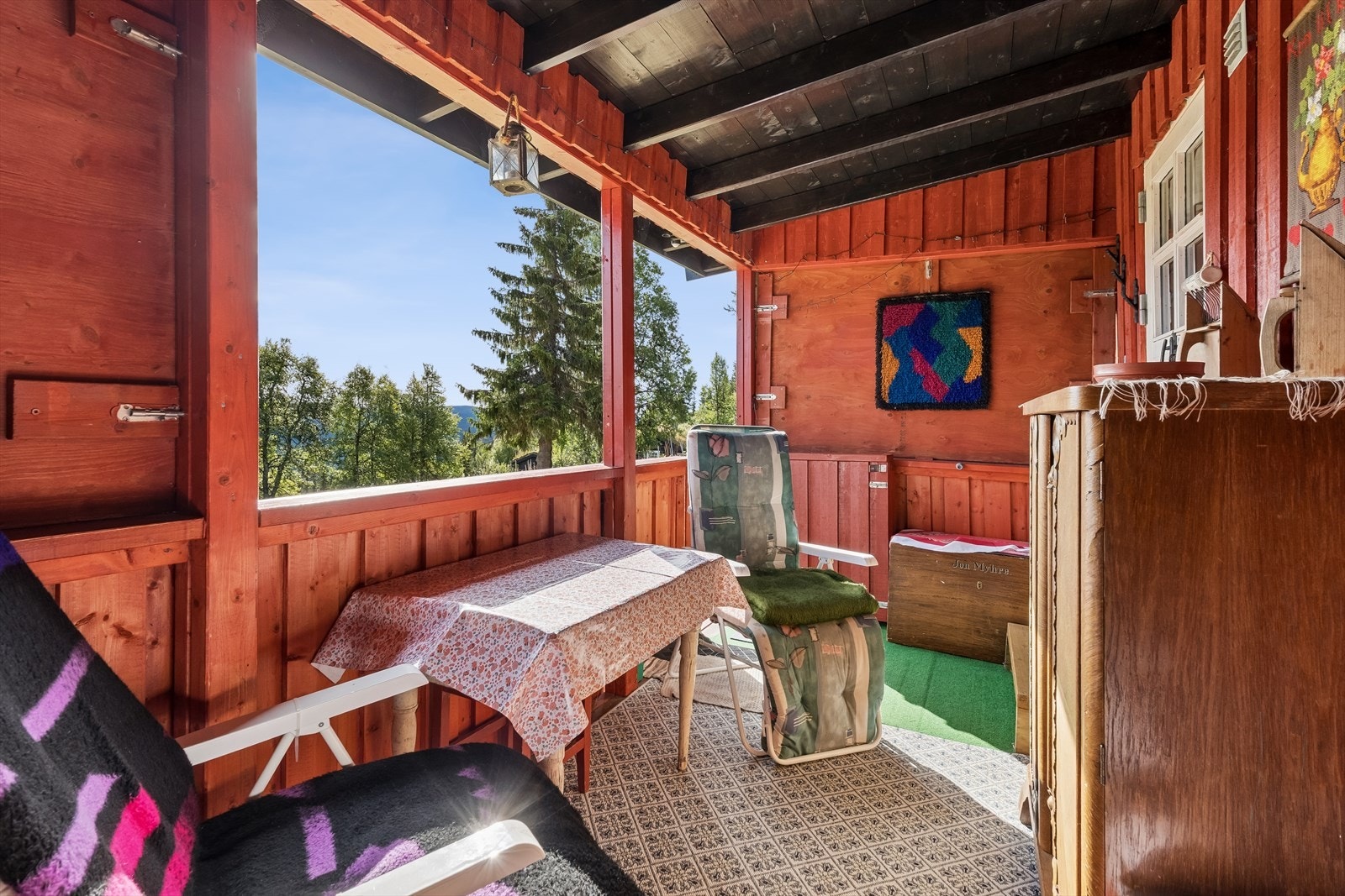 Et lunt og skjermet uterom med rekkverk og vindusåpninger. Verandaen kan åpnes ytterligere ved at plater fjernes. Galleribilde