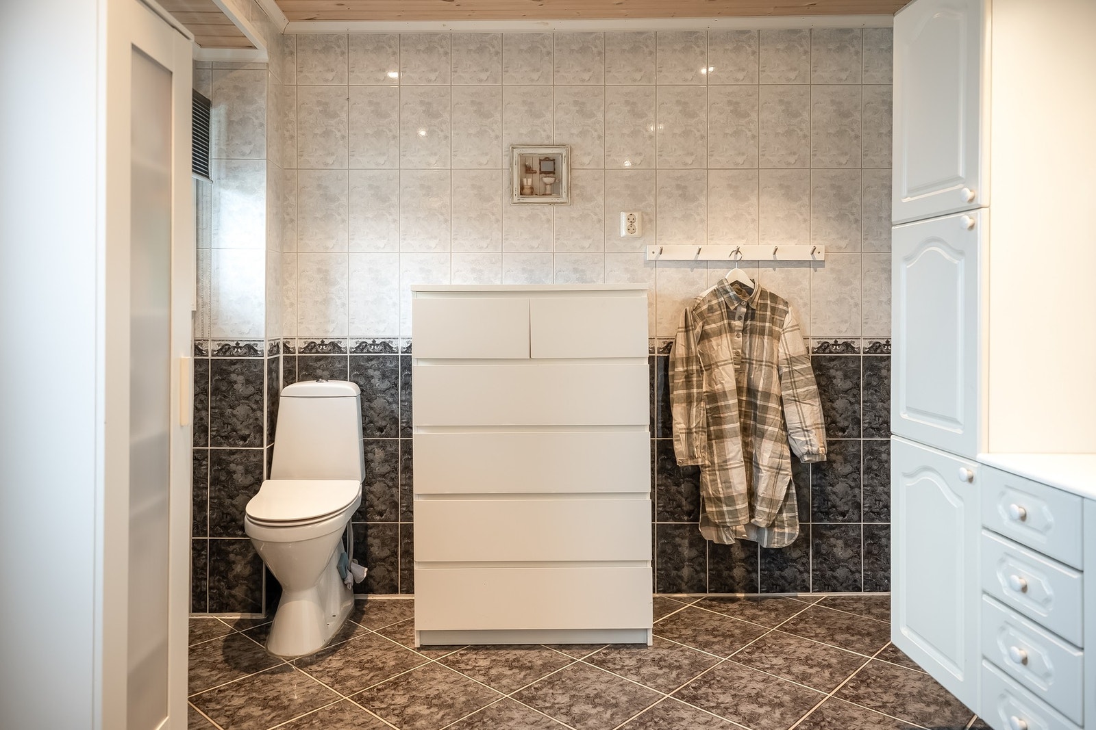 Badet er utstyrt med toalett, servant med innredning, dusjhjørne og opplegg for vaskemaskin. Galleribilde